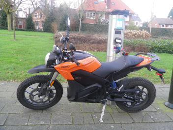 Electric Motor cycle carging at public charger with Adapter Type 2 to Schuko